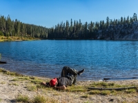 bernie relaxing at the lake after a long day of hiking