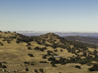 looking down on farm house in valley