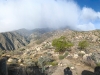 looking up at the top covered in clouds