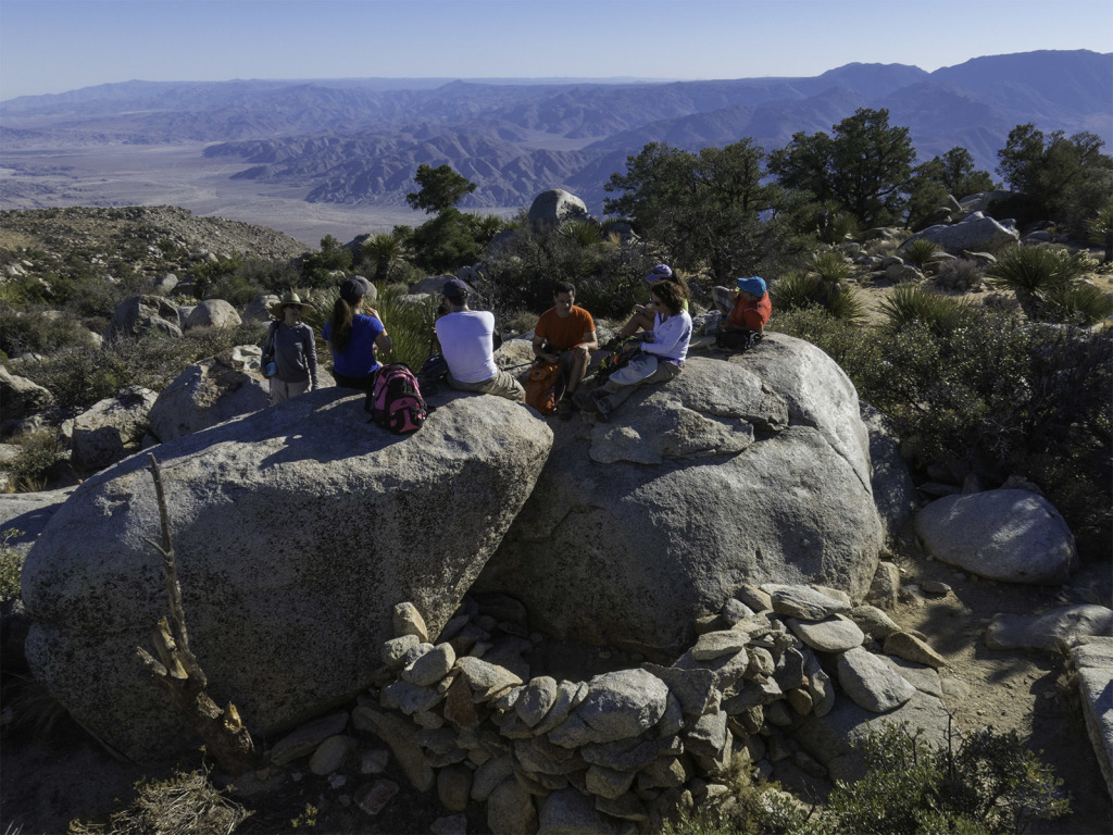 Having lunch on top of a rock with a little wind break built below it.