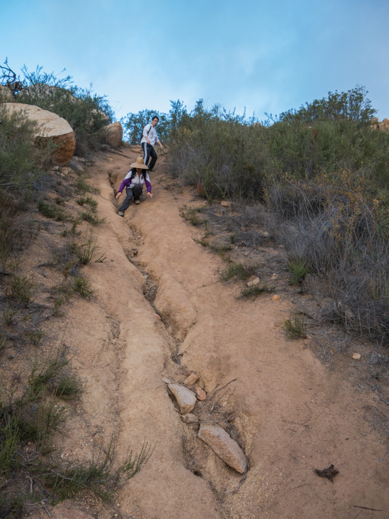 Hikers making their way down the steep terrain on Warren Canyon Trail