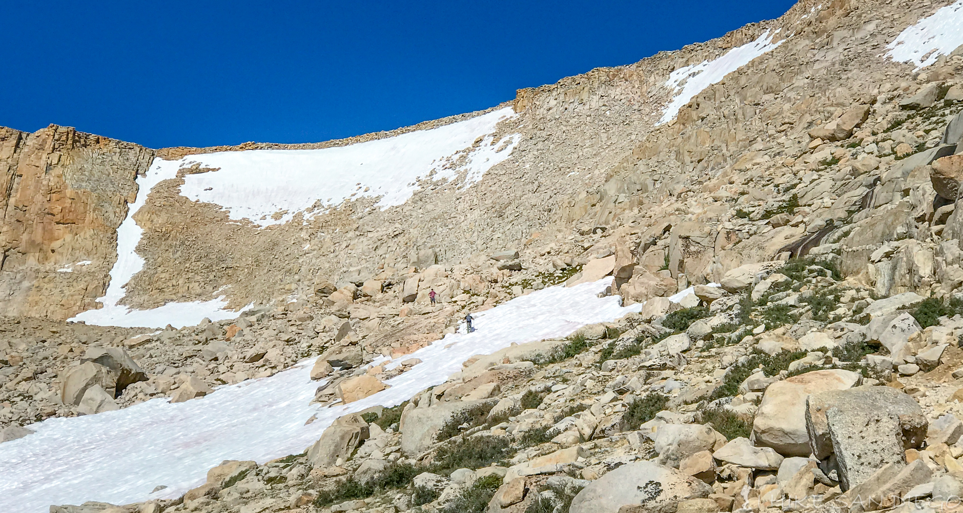 Making our way through fields of rock and snow up New Army Pass