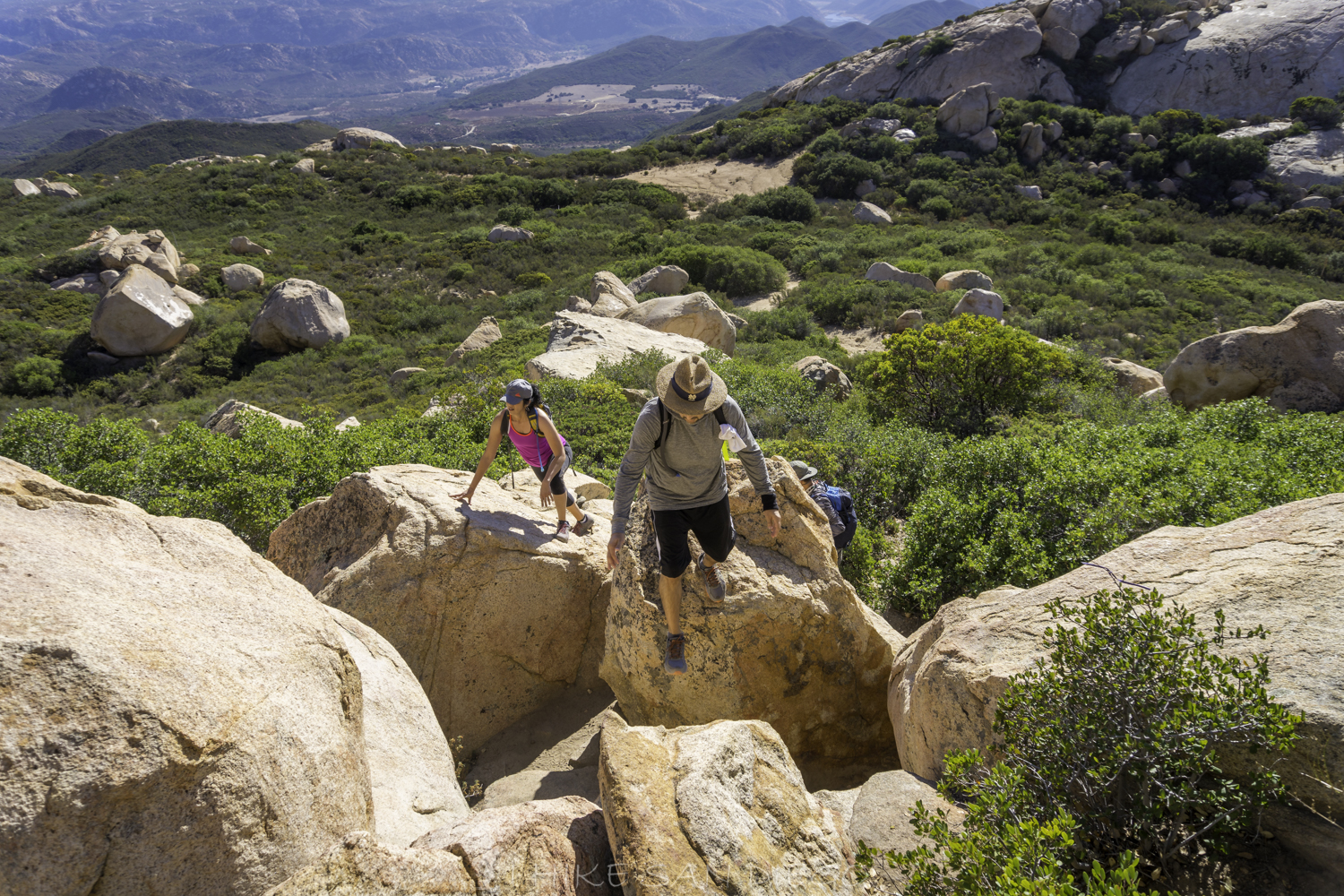 Group of hikers making their way up the boulders on the Lawson Peak Trail