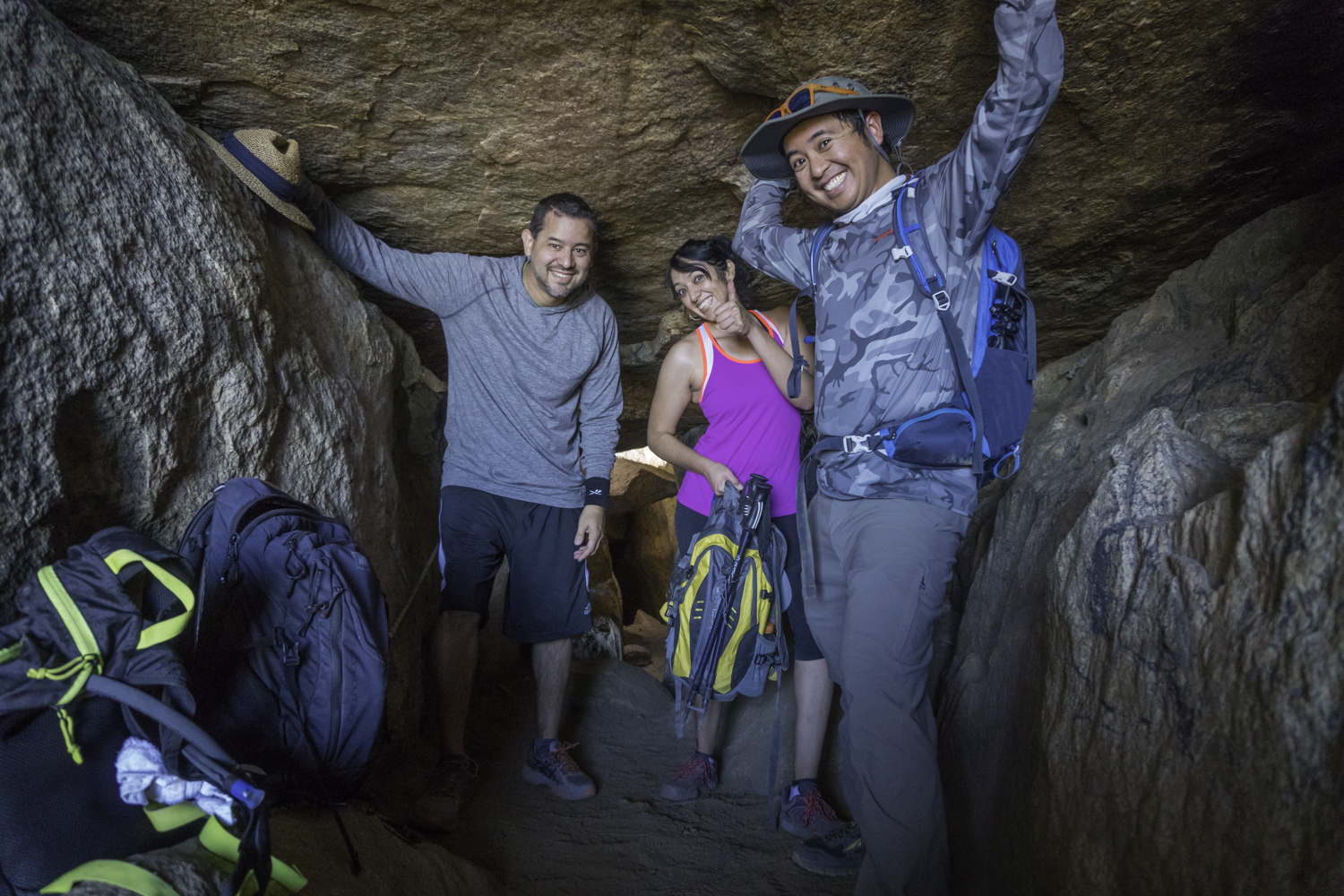Hikers in boulder cave at Lawson Peak